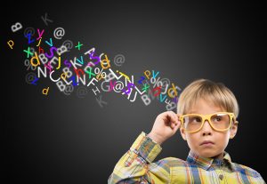 Portrait of a cute young boy in  glasses thinking over background